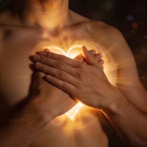 Imagen: manos sobre el corazón emanando luz dorada.